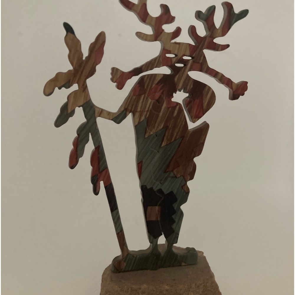 Indian warrior figurine. Metal on sandstone